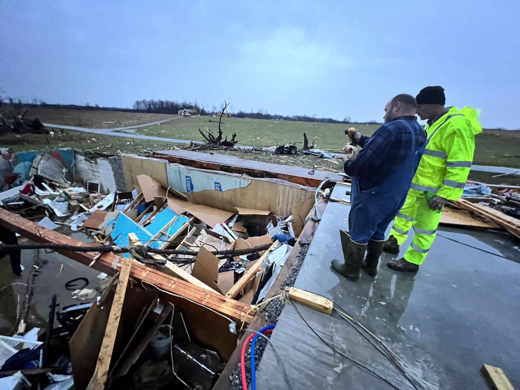 Mitchell Wooldridge stands above a destroyed home after the deadly December 2021 tornadoes